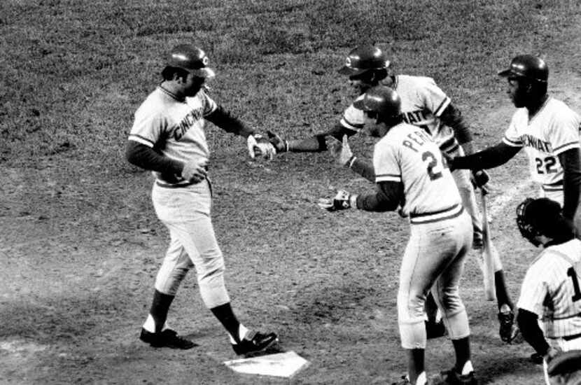 Cincinnati Reds catcher Johnny Bench, left, steps on home plate after his second home run in...