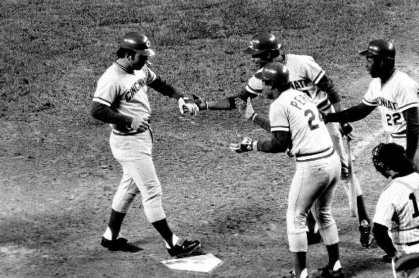 Cincinnati Reds catcher Johnny Bench, left, steps on home plate after his second home run in...