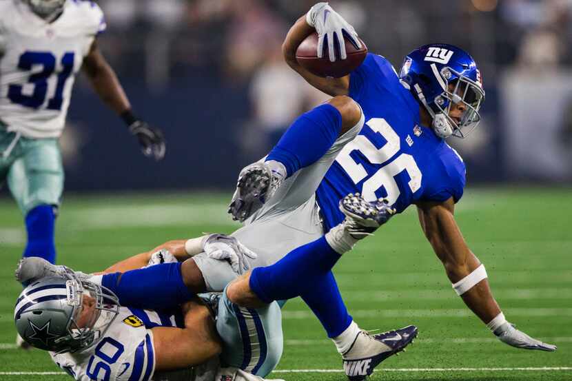 Dallas Cowboys linebacker Sean Lee (50) tackles New York Giants running back Saquon Barkley...