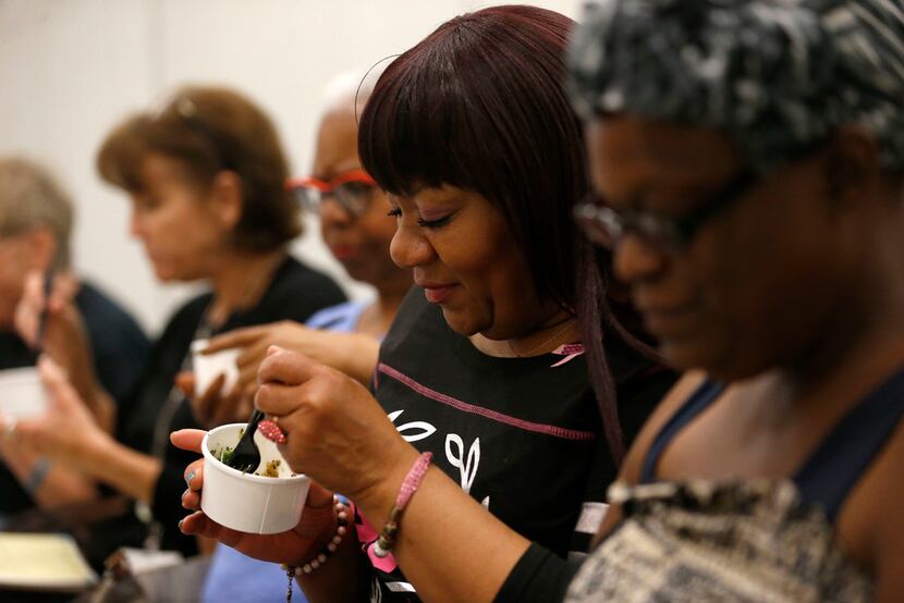 Barbara Edwards tries pesto broccoli during cooking class at Cvetko Patient Resource Center.