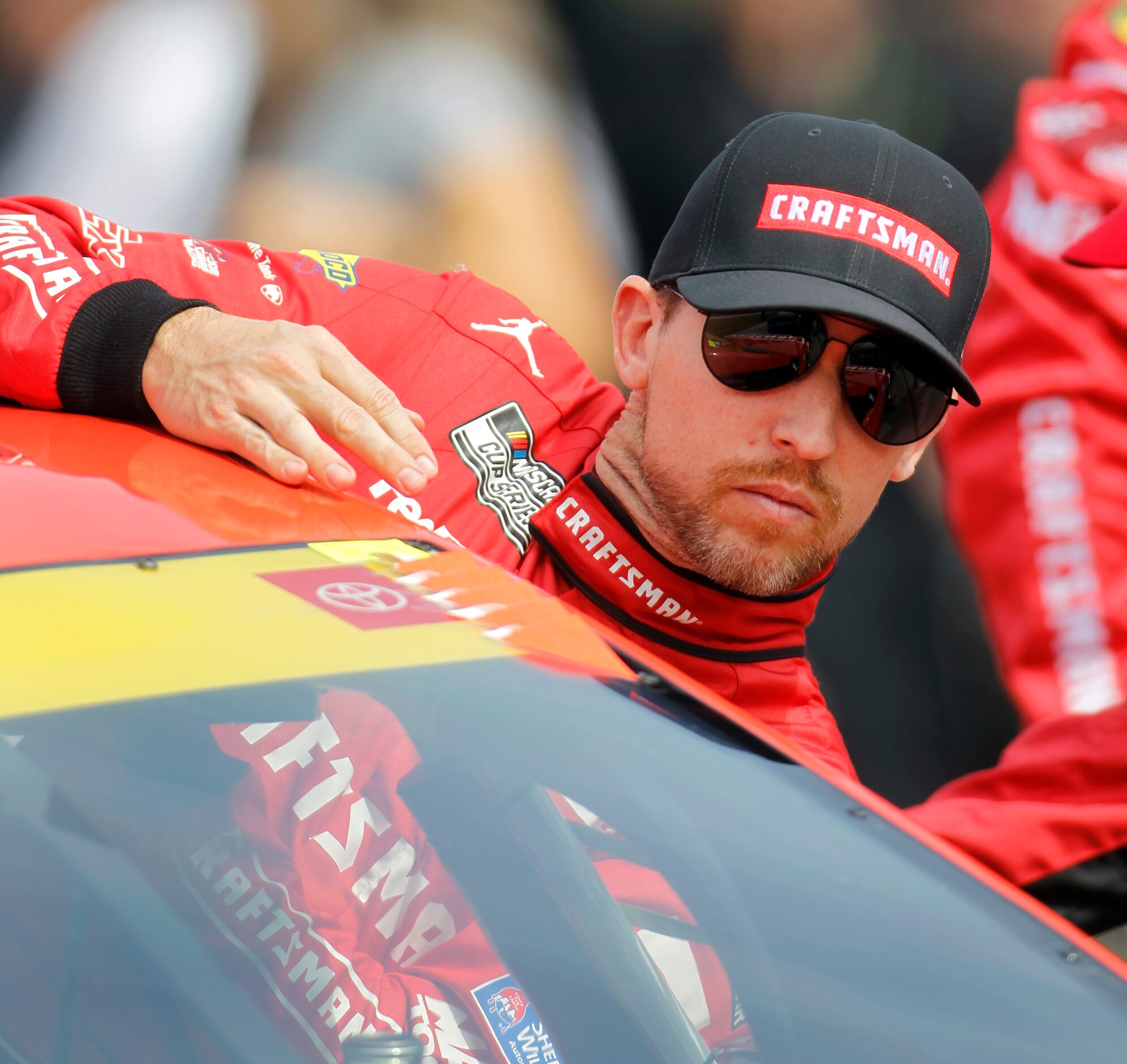 Driver Denny Hamlin crawls into the number 11Craftsman Toyota car just prior to the start of...