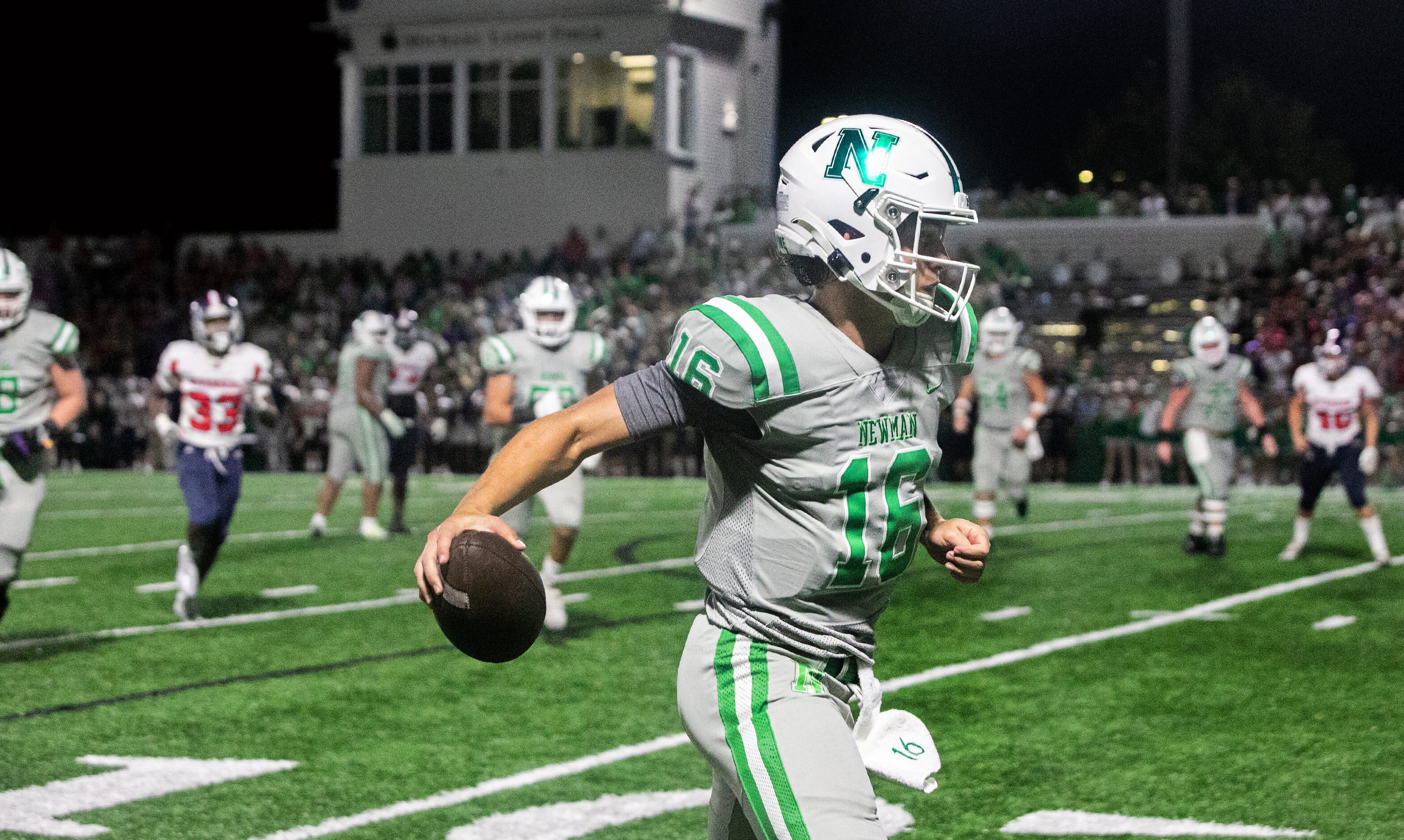 Arch Manning scrambles for the end zone during a touchdown run as Newman High School takes...