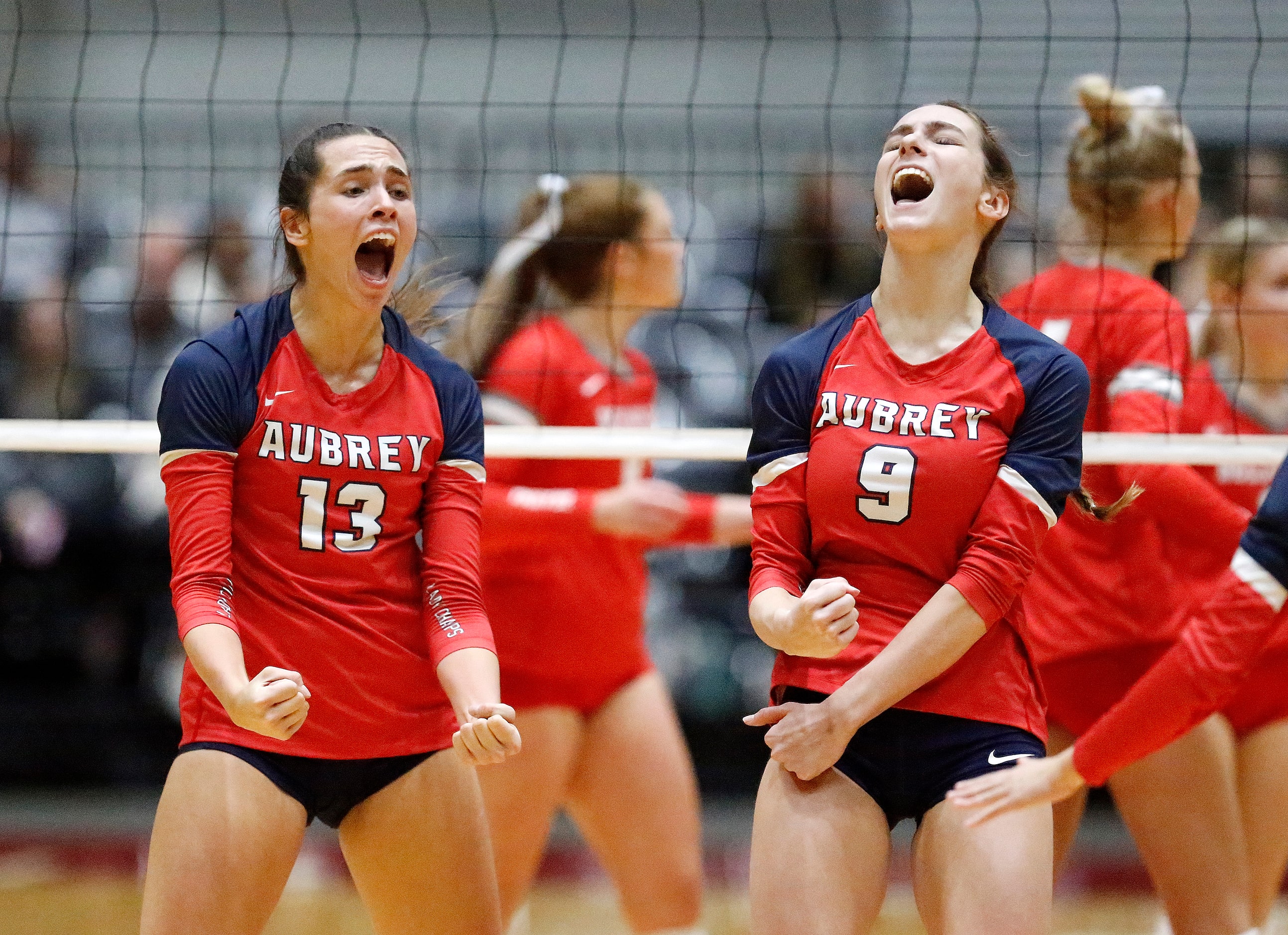 Aubrey High School’s Sydney Garrison (13) and Annaleise Sevier (9) celebrate a point during...