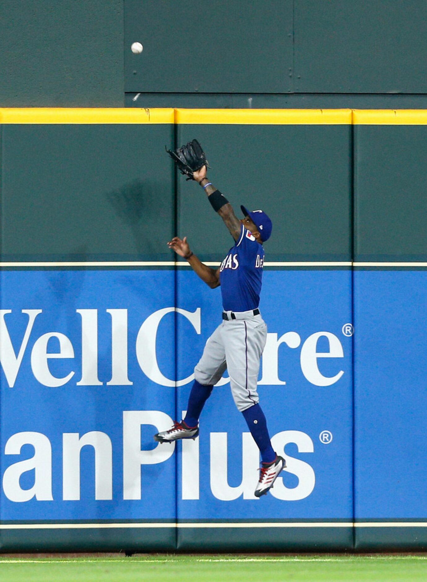 HOUSTON, TX - JULY 29:  Delino DeShields #3 of the Texas Rangers leaps at the wall but is...