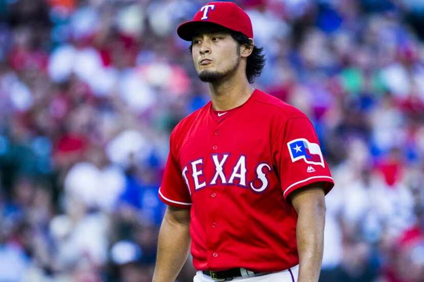 Texas Rangers starting pitcher Yu Darvish (11) walks off the field after the top of third...