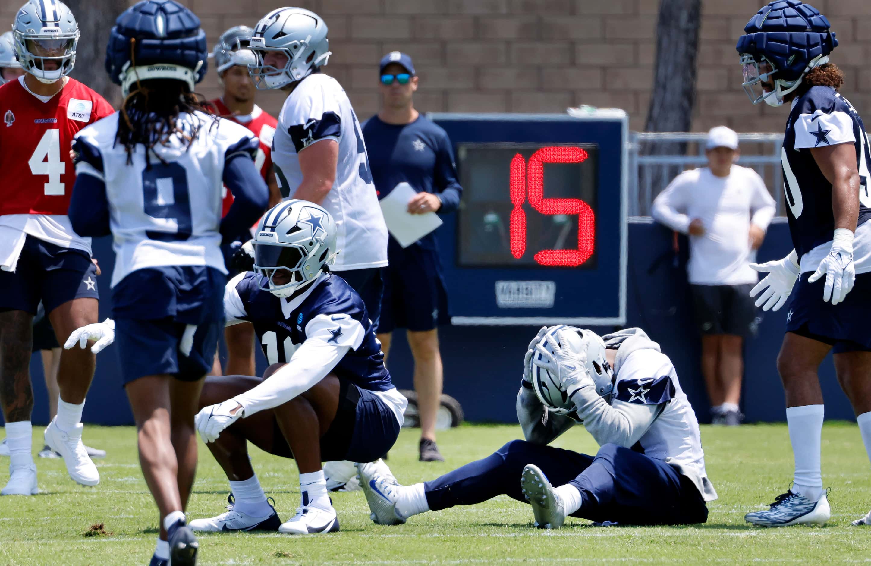 Dallas Cowboys running back Ezekiel Elliott (15) holds his helmet after he was unable to...