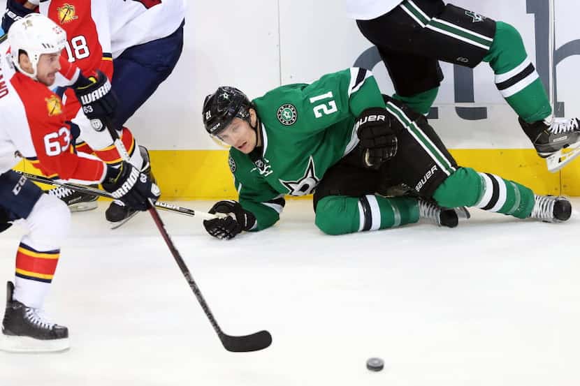 Dallas Stars left wing Antoine Roussel (21) gets tangled up with Dallas Stars defenseman...