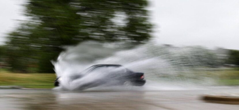 A car plowed through standing water on West Green Oaks Boulevard in Arlington after...