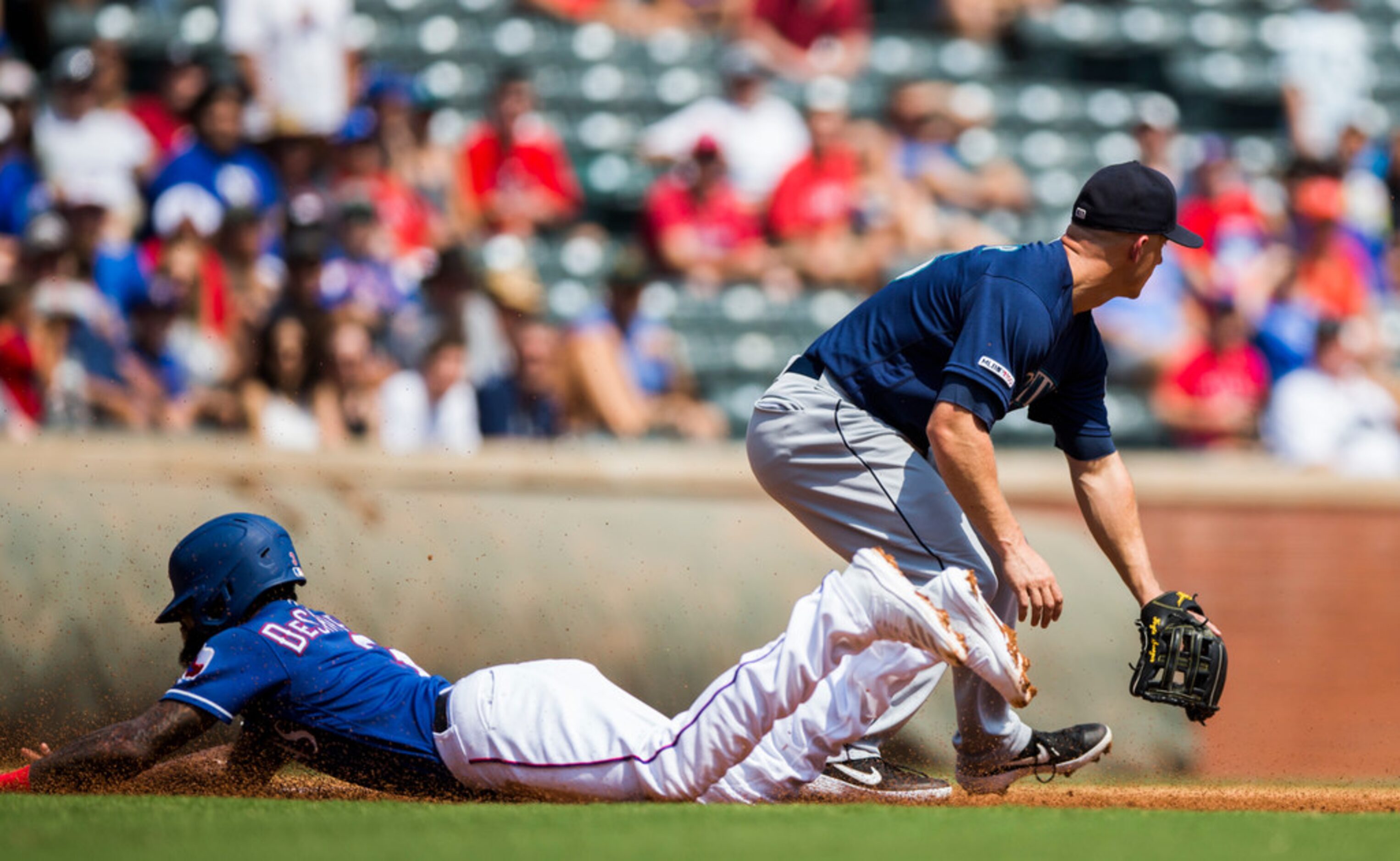 Texas Rangers center fielder Delino DeShields (3) makes it safely to third ahead of Seattle...