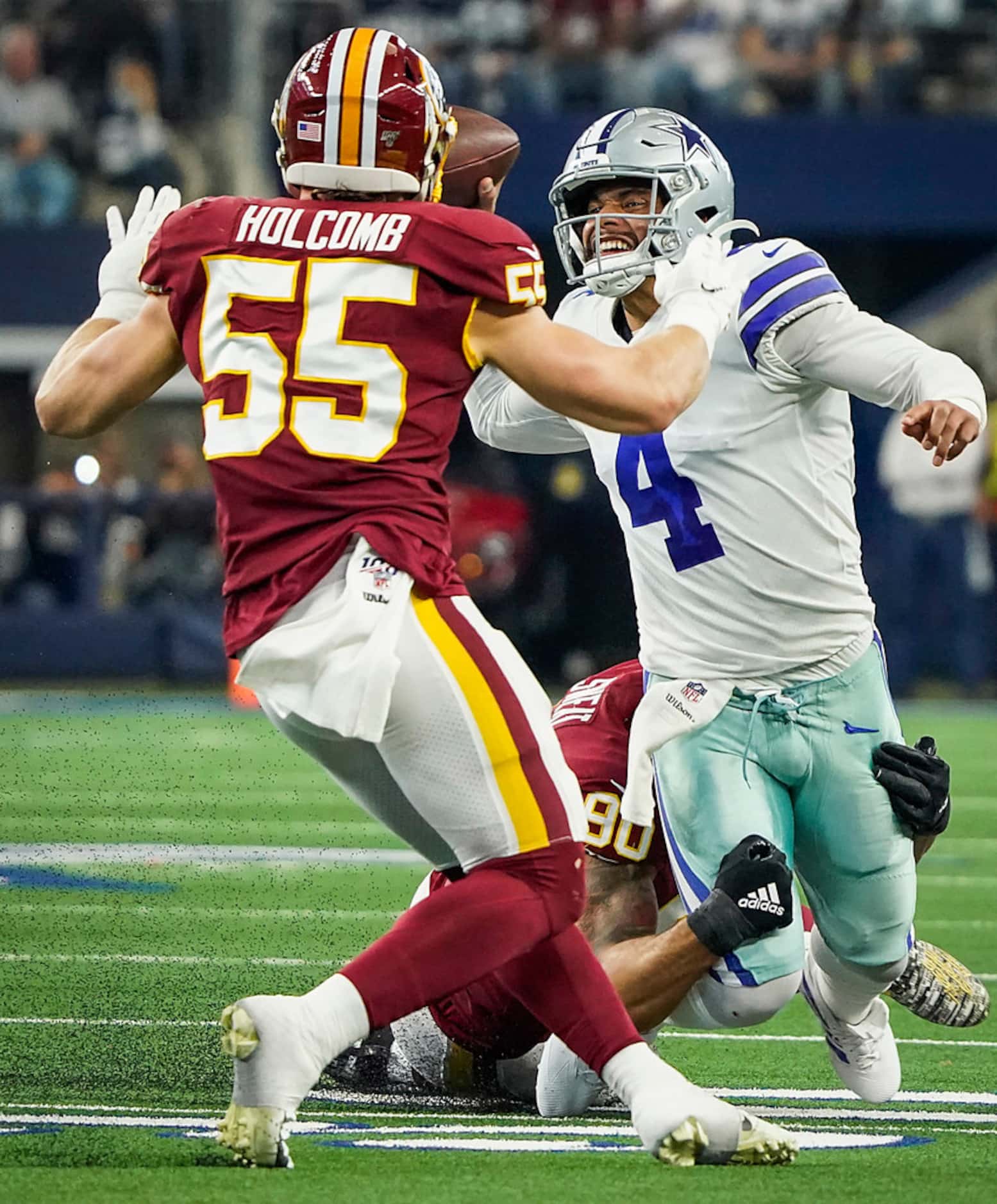 Dallas Cowboys quarterback Dak Prescott (4) tries to pass as is chased down by Washington...