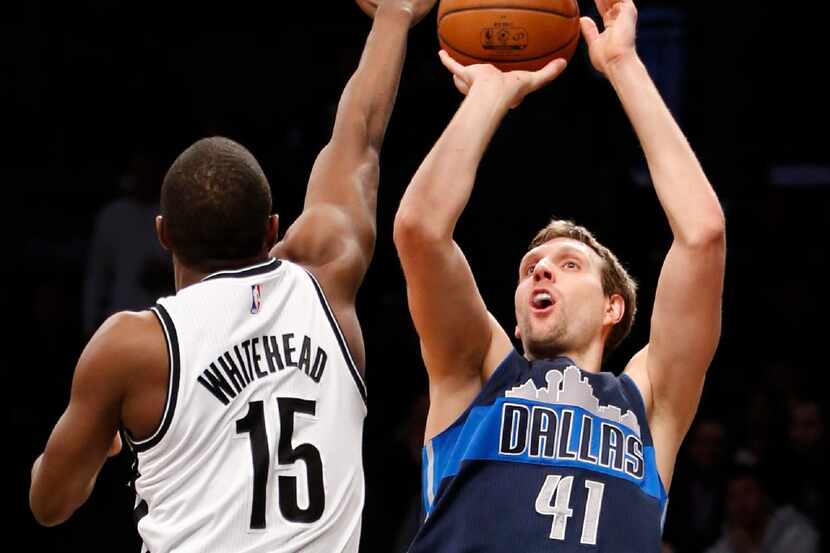 Brooklyn Nets guard Isaiah Whitehead (15) defends as the Mavericks' Dirk Nowitzki (41)...
