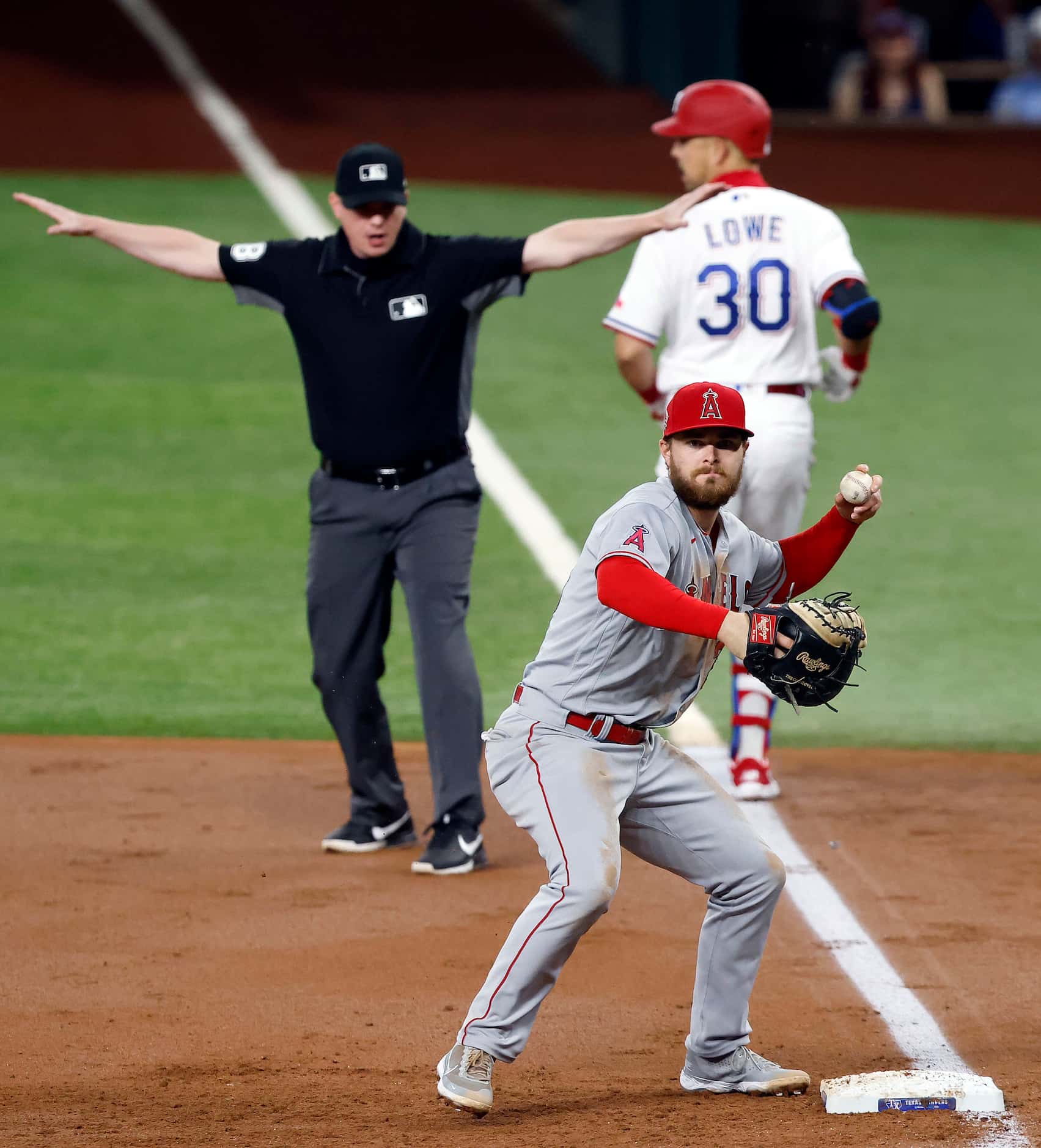 Texas Rangers batter Nate Lowe (30) is safe at first after Los Angeles Angels first baseman...