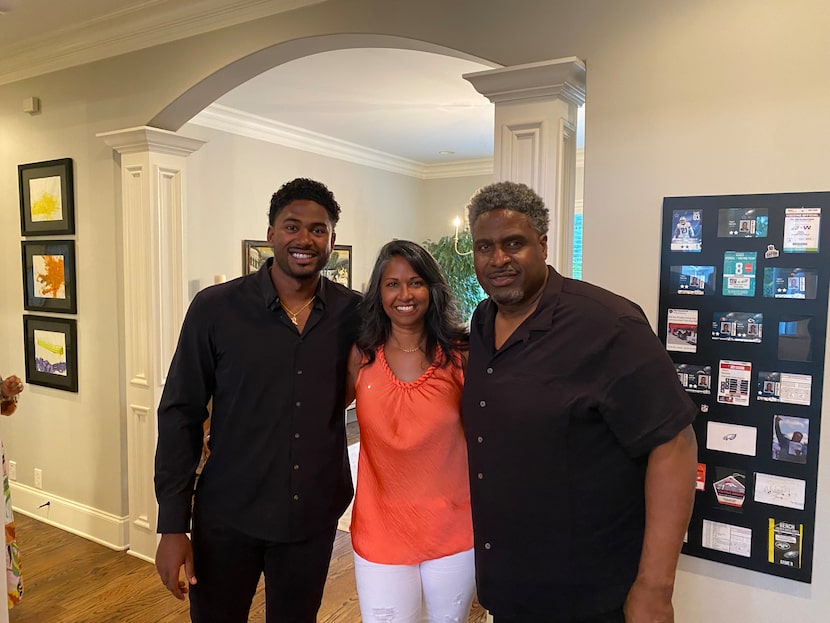 Texas Rangers pitcher Kumar Rocker, left, is pictured with mom Lalitha and dad Tracy...