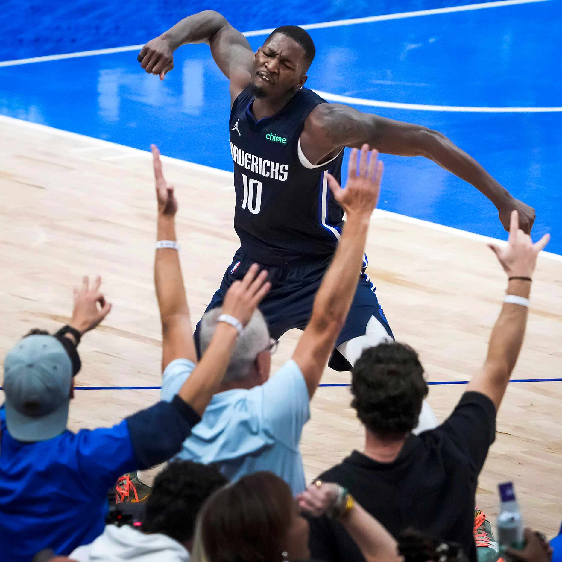 Dallas Mavericks forward Dorian Finney-Smith celebrates after hitting a 3-pointer to give...