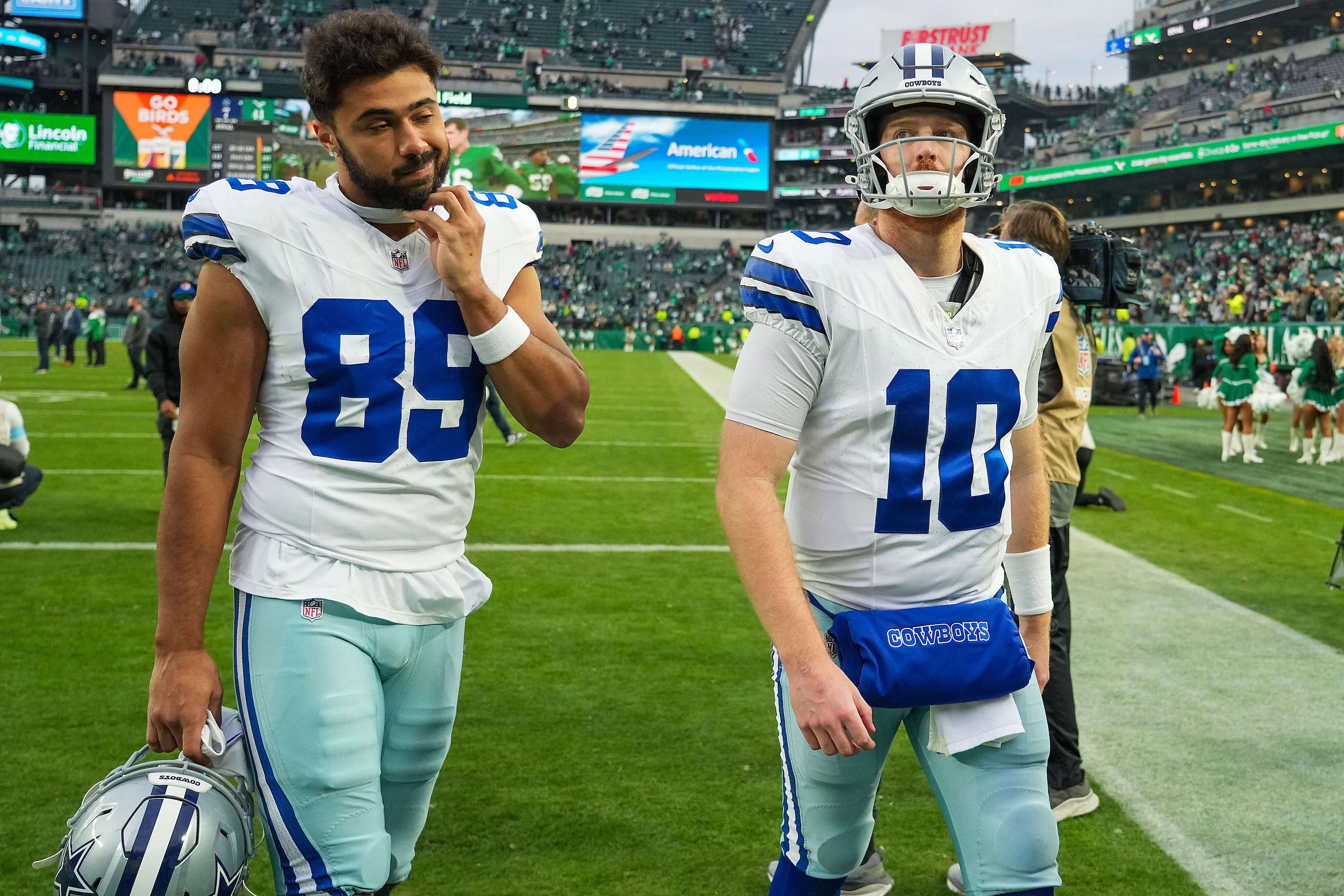 Dallas Cowboys quarterback Cooper Rush (10) and tight end Brevyn Spann-Ford (89) leave the...