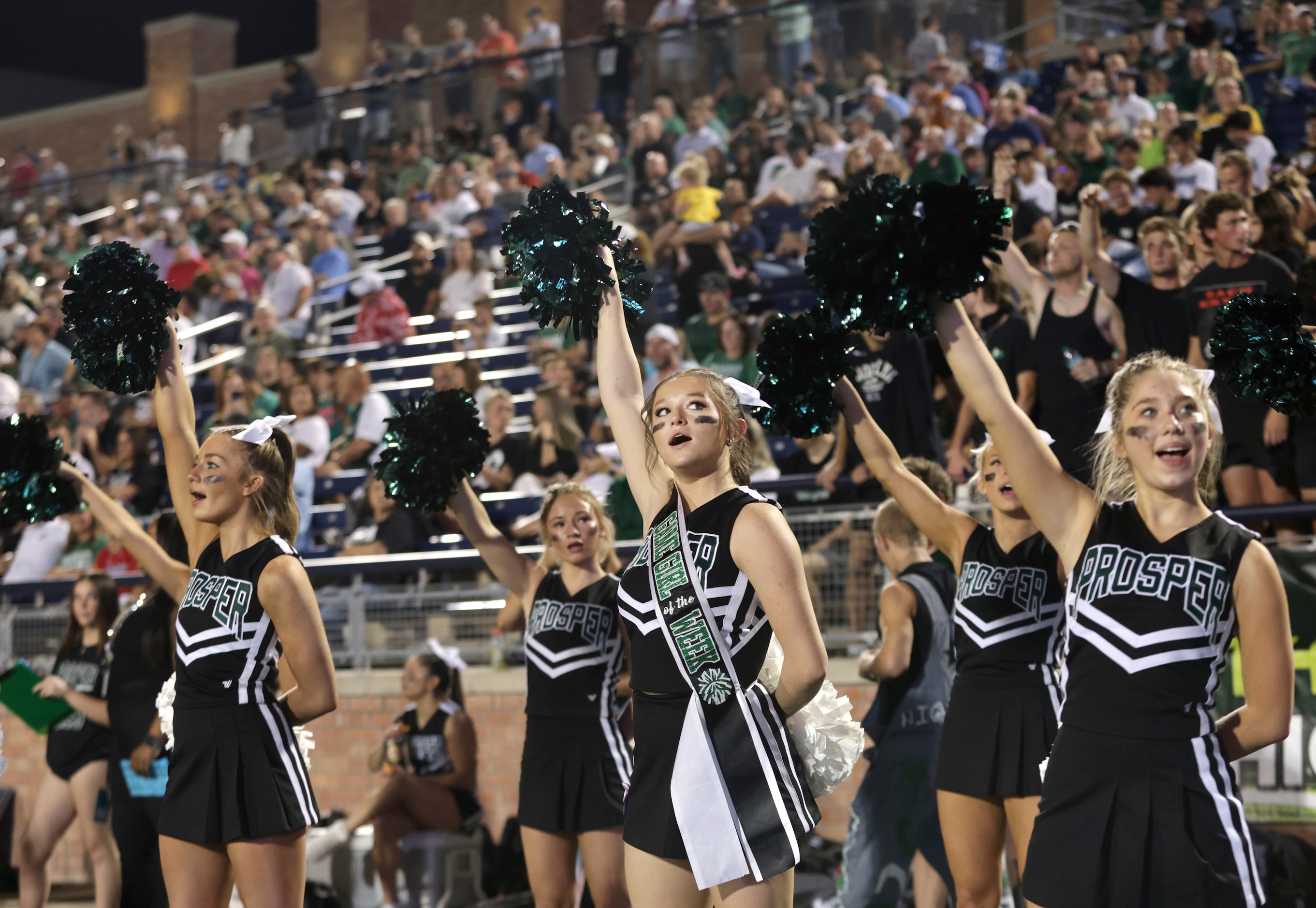 The Prosper cheerleaders motivate the crowd during the Prosper High School at Allen High...