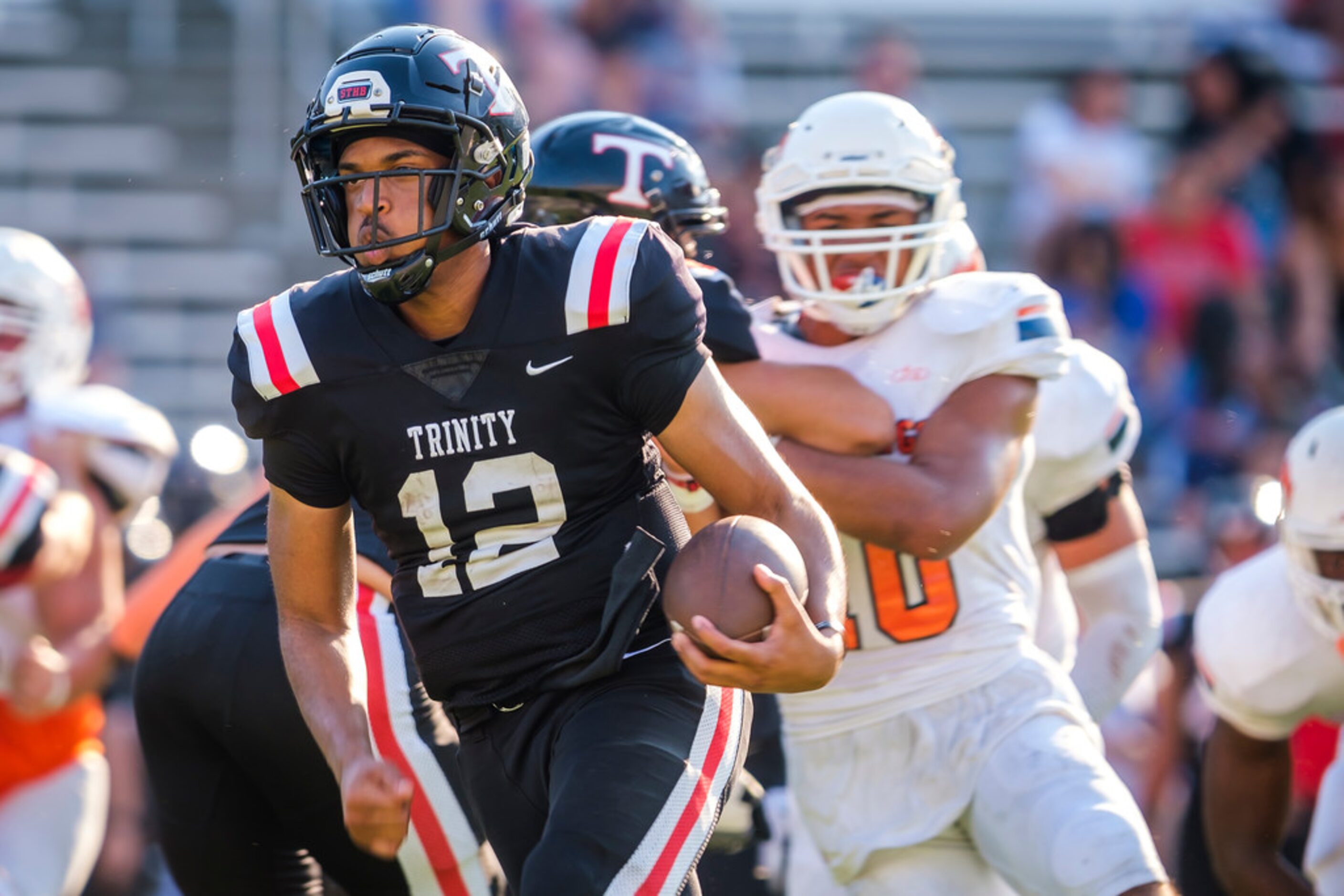 Euless Trinity quarterback Marcus Ervin (12) breaks through the Sachse defense during the...