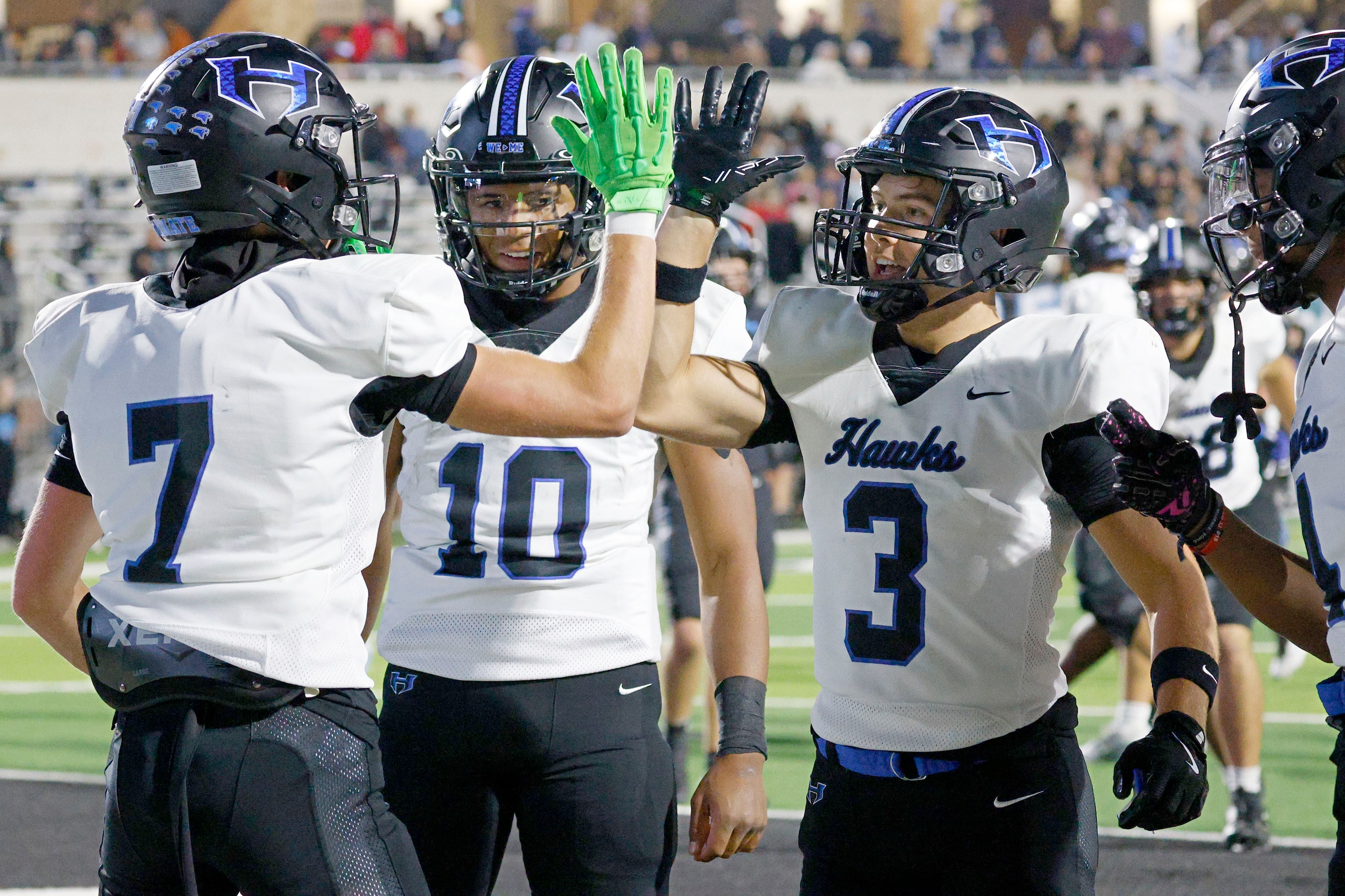 Hebron's Tyler Hoke (7) celebrates with his teammates Patrick Crayton Jr. (10) and Drew...