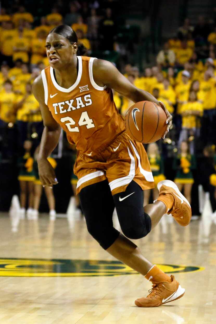 Texas forward Joyner Holmes dribbles up court against Baylor during an NCAA college...