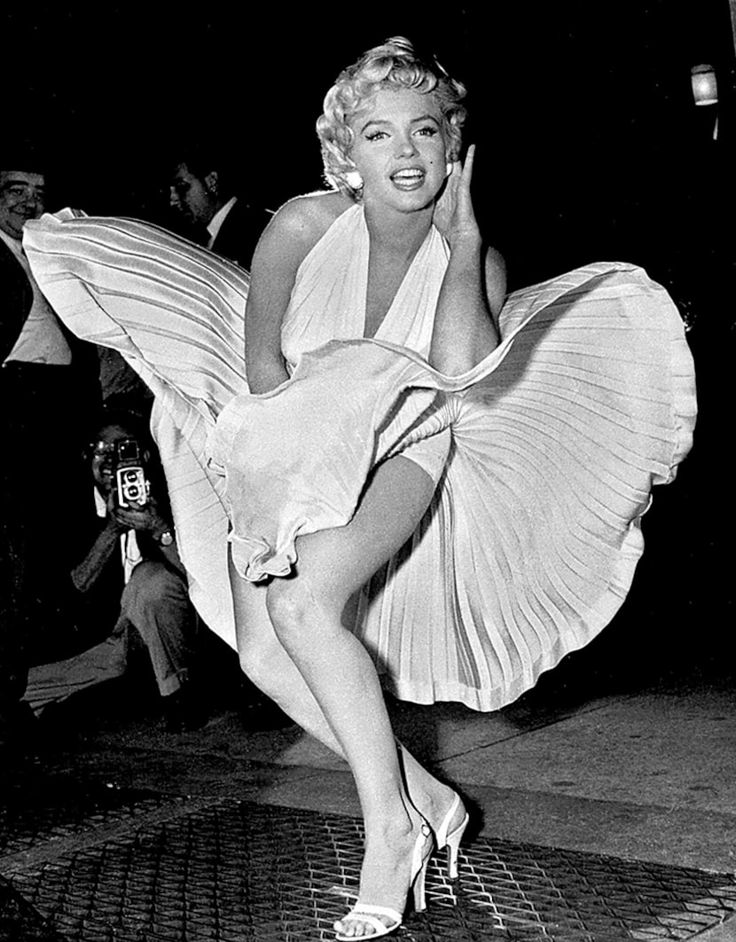  Marilyn Monroe poses over the updraft of a New York subway grating while in character for...