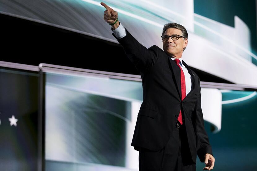 Former Texas Gov. Rick Perry points to the crowd during the second session of the Republican...