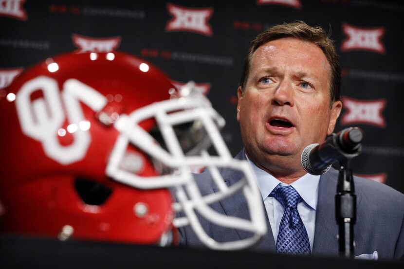 FILE - Then-Oklahoma coach Bob Stoops answers a question during Big 12 Conference media days...