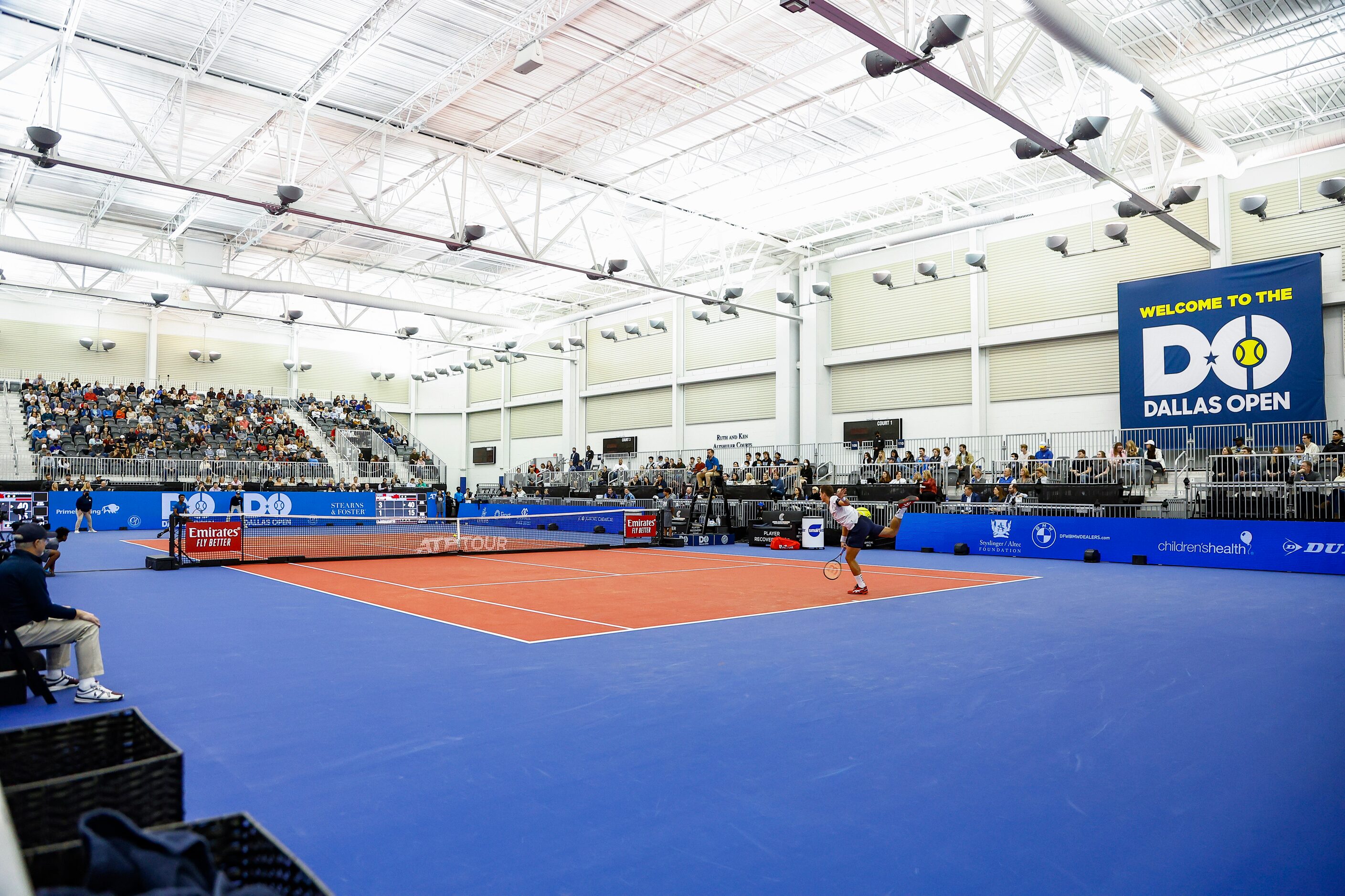 SMU senior Caleb Chakravarthi, far side, competes against Vasek Pospisil in a tennis match...