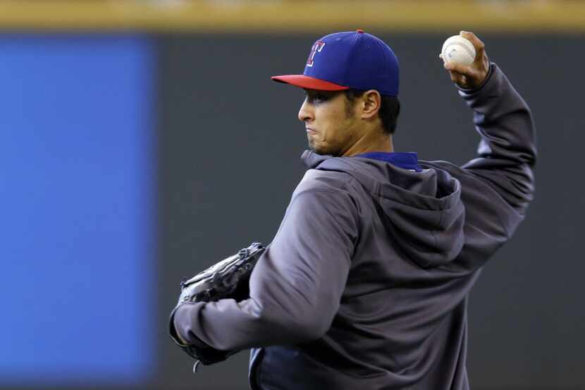 Texas Rangers pitcher Yu Darvish throws in the outfield on Sunday, April 27, 2014, before a...