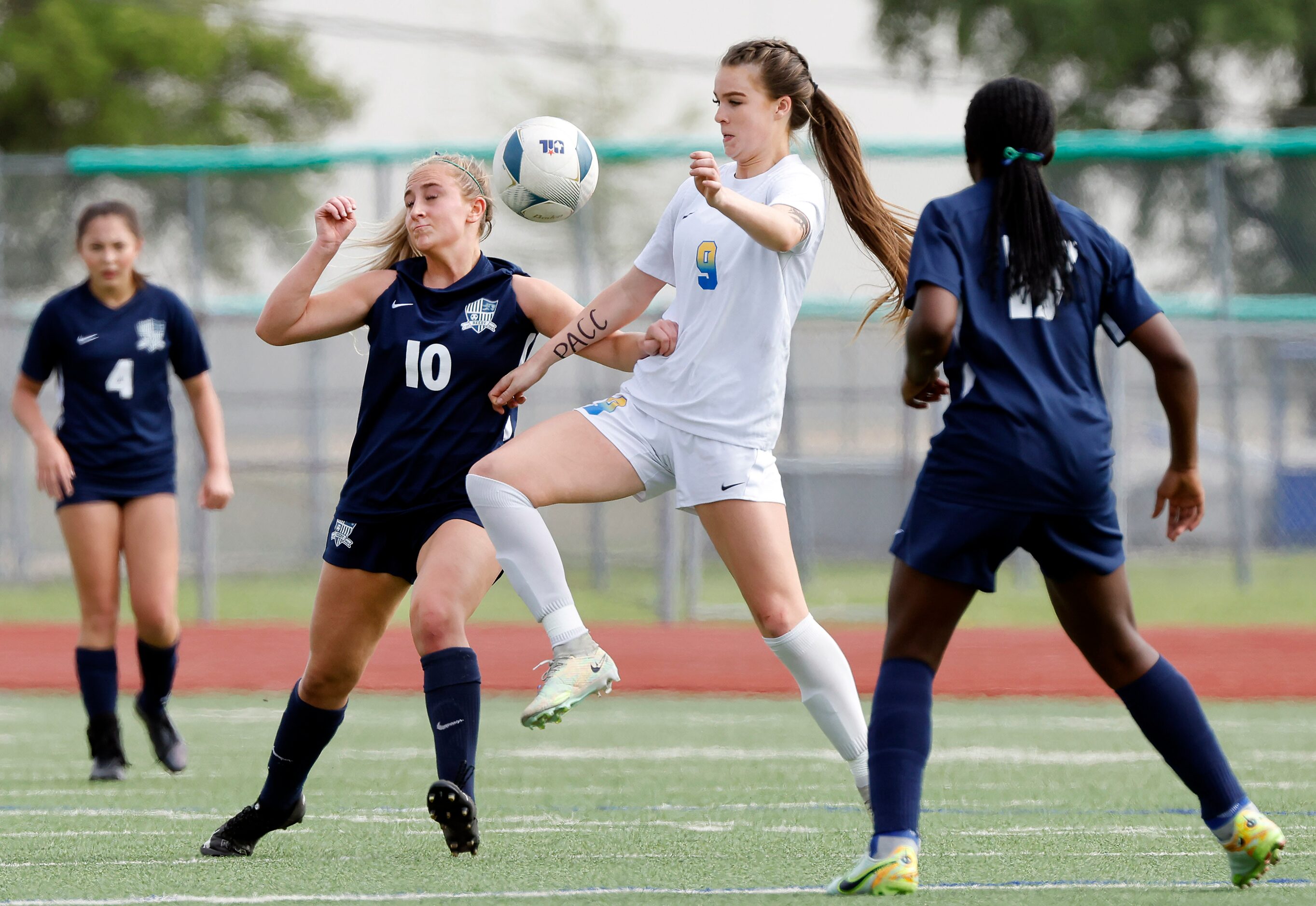 Frisco’s Kat Campbell (9) battles Frisco Reedy’s Alena Ultes (10) for control of the ball...