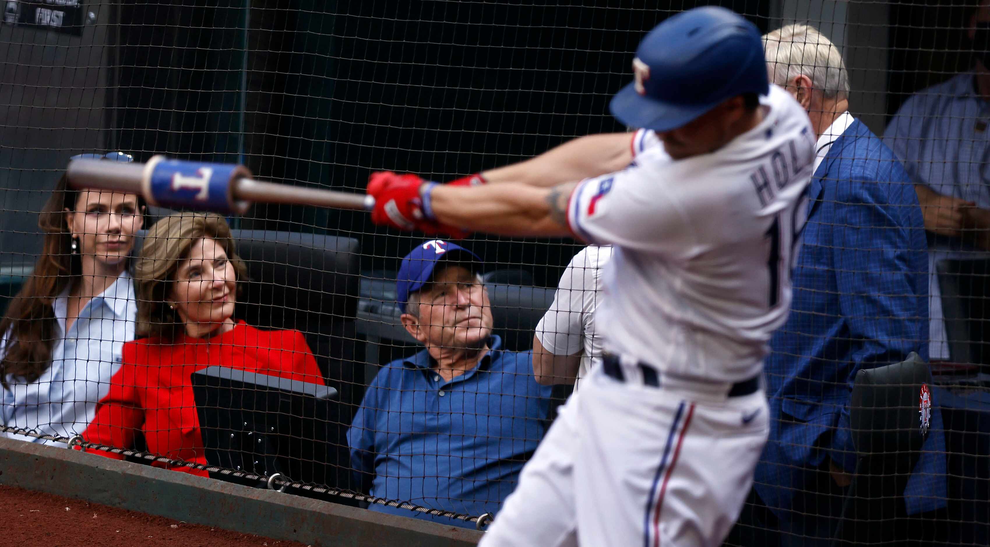 Former President George W. Bush (center) visits with Rangers co-owner Ray Davis as he sits...