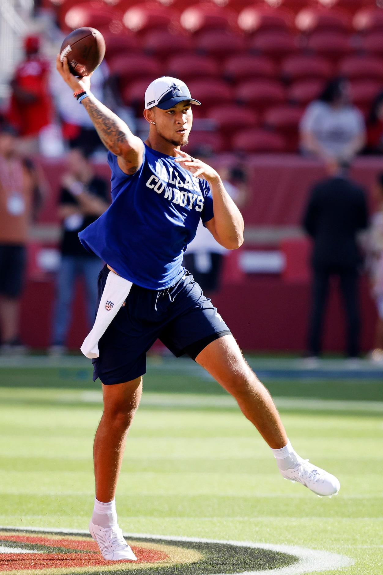 Dallas Cowboys quarterback Trey Lance (15) rolls out during pregame warmups before the team...