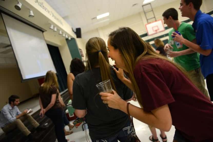
Graduating senior Anastasia Miculka reacts to a class video during a reunion with former...