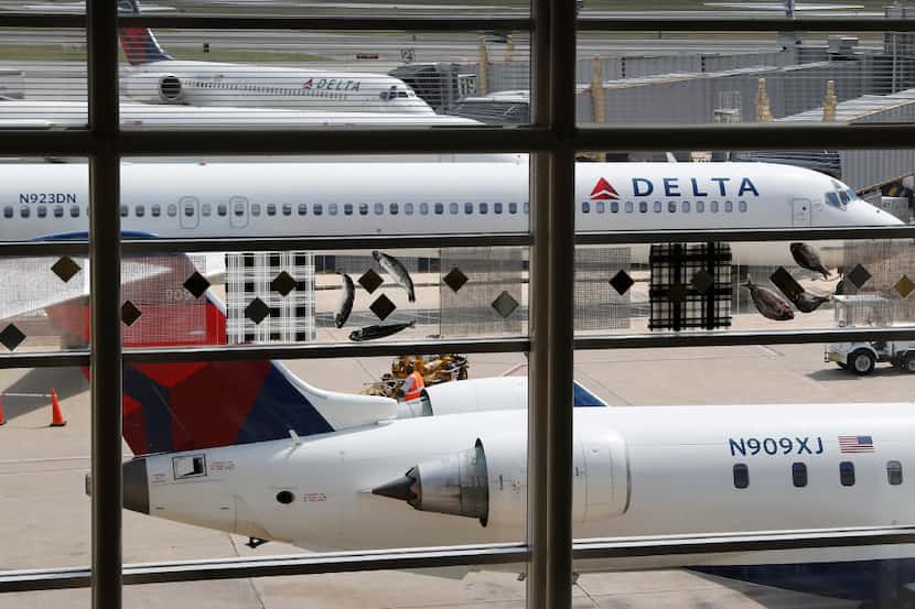 In this Monday, Aug. 8, 2016, file photo, Delta Air Lines planes are parked at Ronald Reagan...