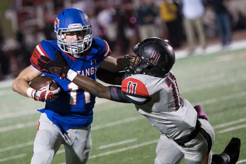 Grapevine running back Zach Wolf (11) attempts to break a tackle during Grapevine's matchup...