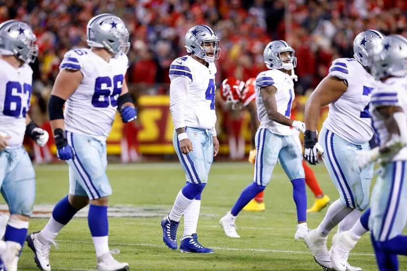 Dallas Cowboys quarterback Dak Prescott (4) walks to the bench with the offense after he was...