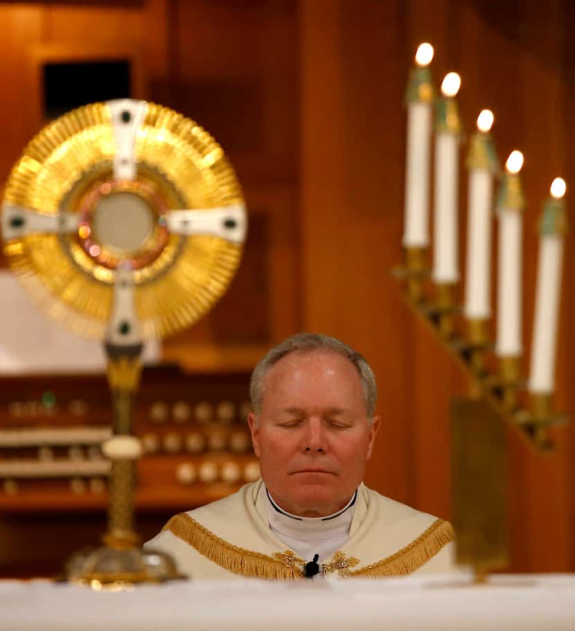 Bishop Edward Burns, the new bishop of Dallas, prays during the Advent Holy Hour mass at St....