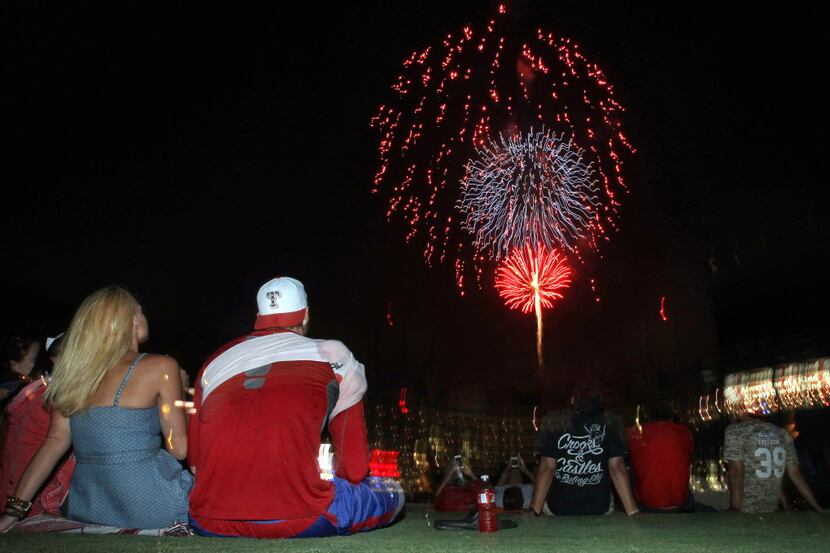 Texas closer Joe Nathan watches the fireworks with teammates, family and friends from the...