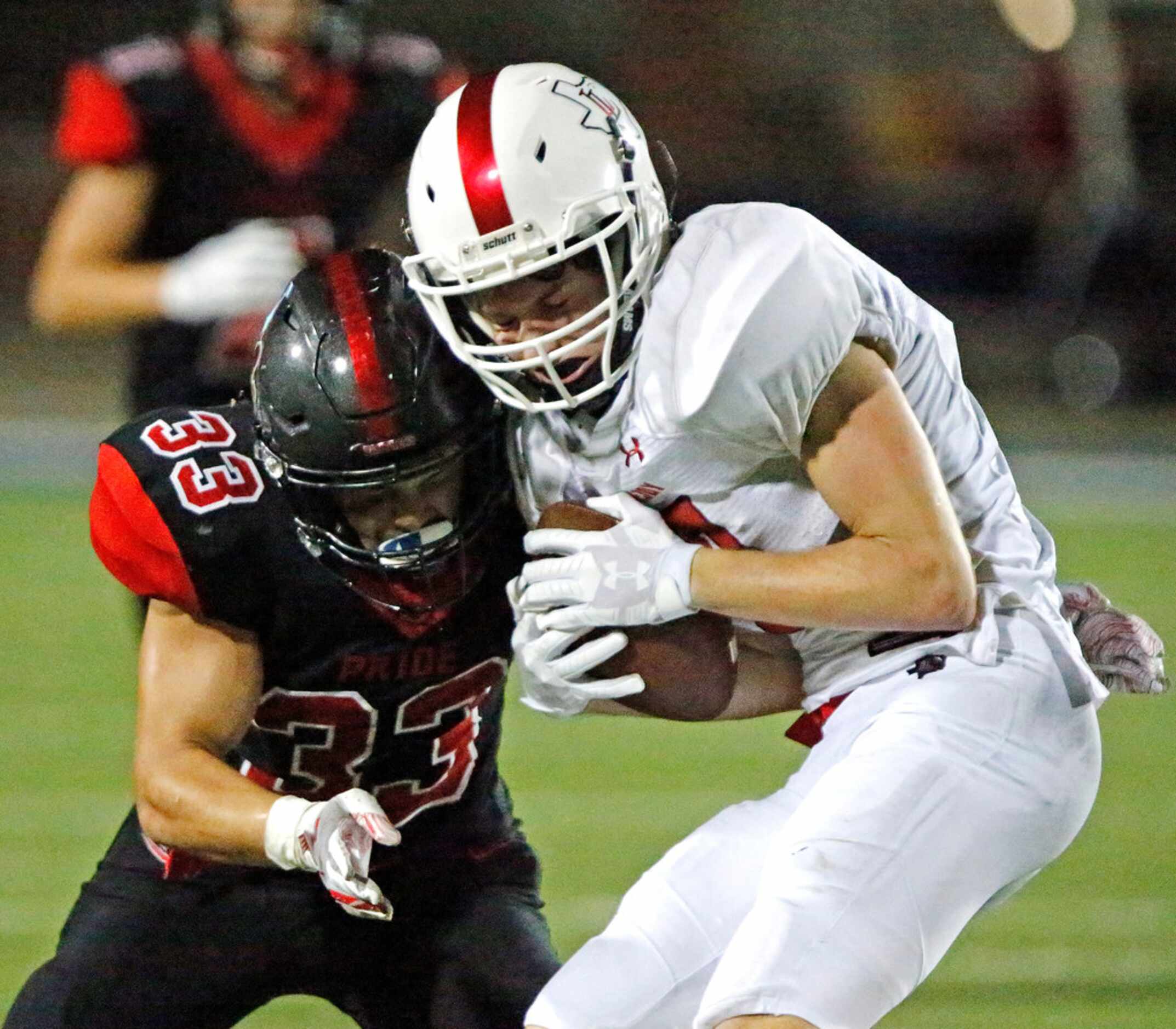 Lovejoy High School wide receiver Reid Westervelt (9) collides with Colleyville Heritage...