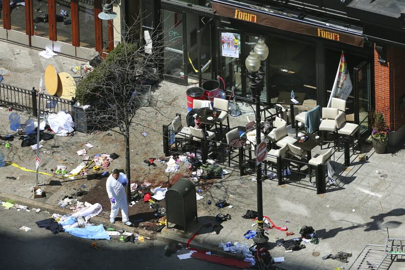Investigators at the scene of the second explosion that occurred during the Boston Marathon...