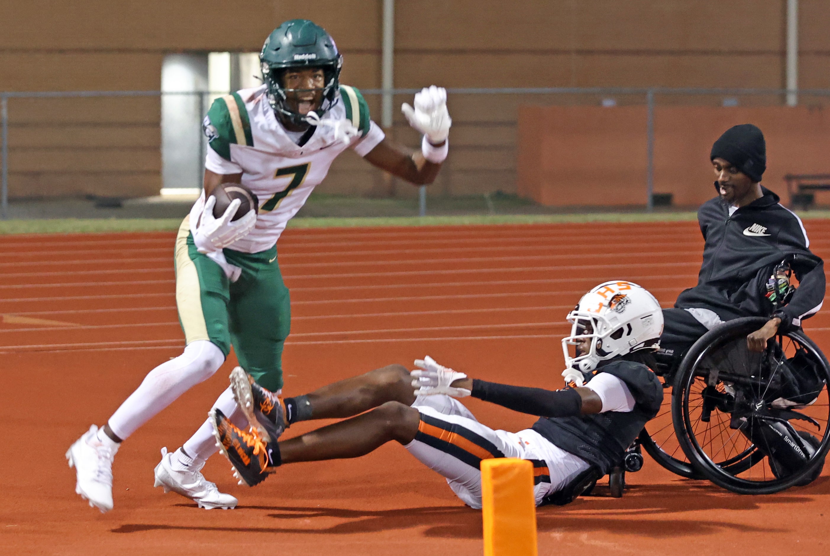 DeSoto High receiver Eathan Feaster (7) celebrates over a Lancaster High defender after...