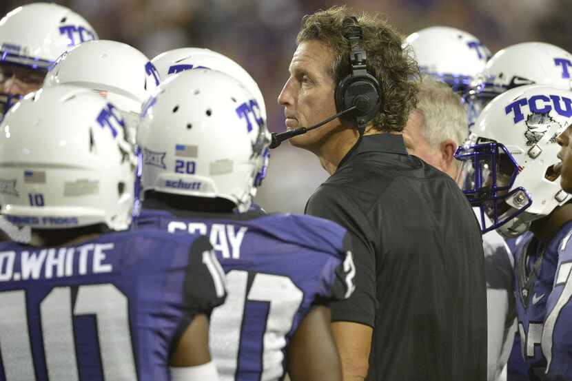 TCU Horned Frogs Co-offensive Doug Meacham talks to his team during the second half as TCU...
