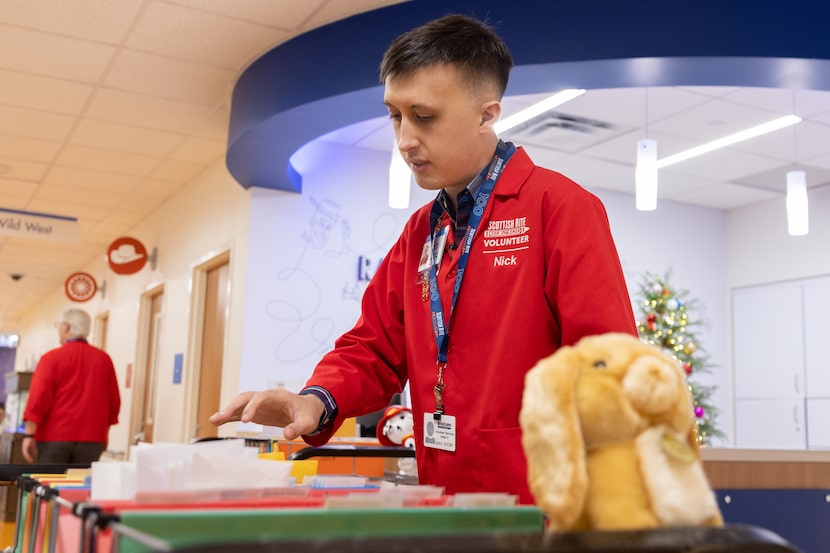 Nick Bloczynski (center) and Tom Shehan make their mail rounds at the Scottish Rite Hospital...