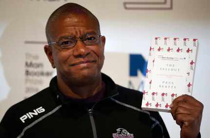 Writer Paul Beatty poses for the media with his book "The Sellout" during a photocall for...