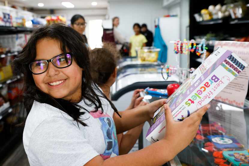 Evelyn Balderas reacts as she opens a gift of a friendship bracelet maker at La Tiendita on...