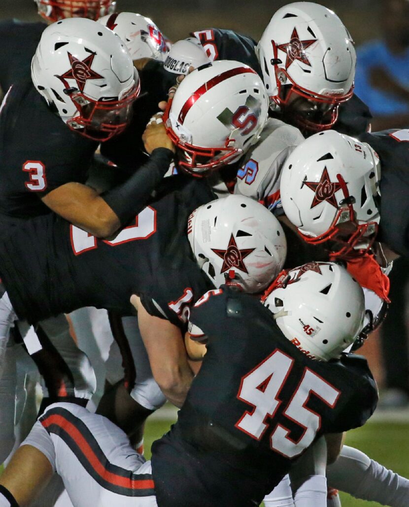 A host of Coppell defenders make the stop on Skyline running back Jordan Hudson (5) in the...