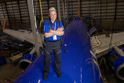 Jennifer Morgan, aircraft maintenance inspector, posed for a photo on top of a plane in...