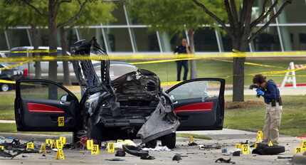  A member of the FBI Evidence Response team documents the crime scene on May 4 after two...