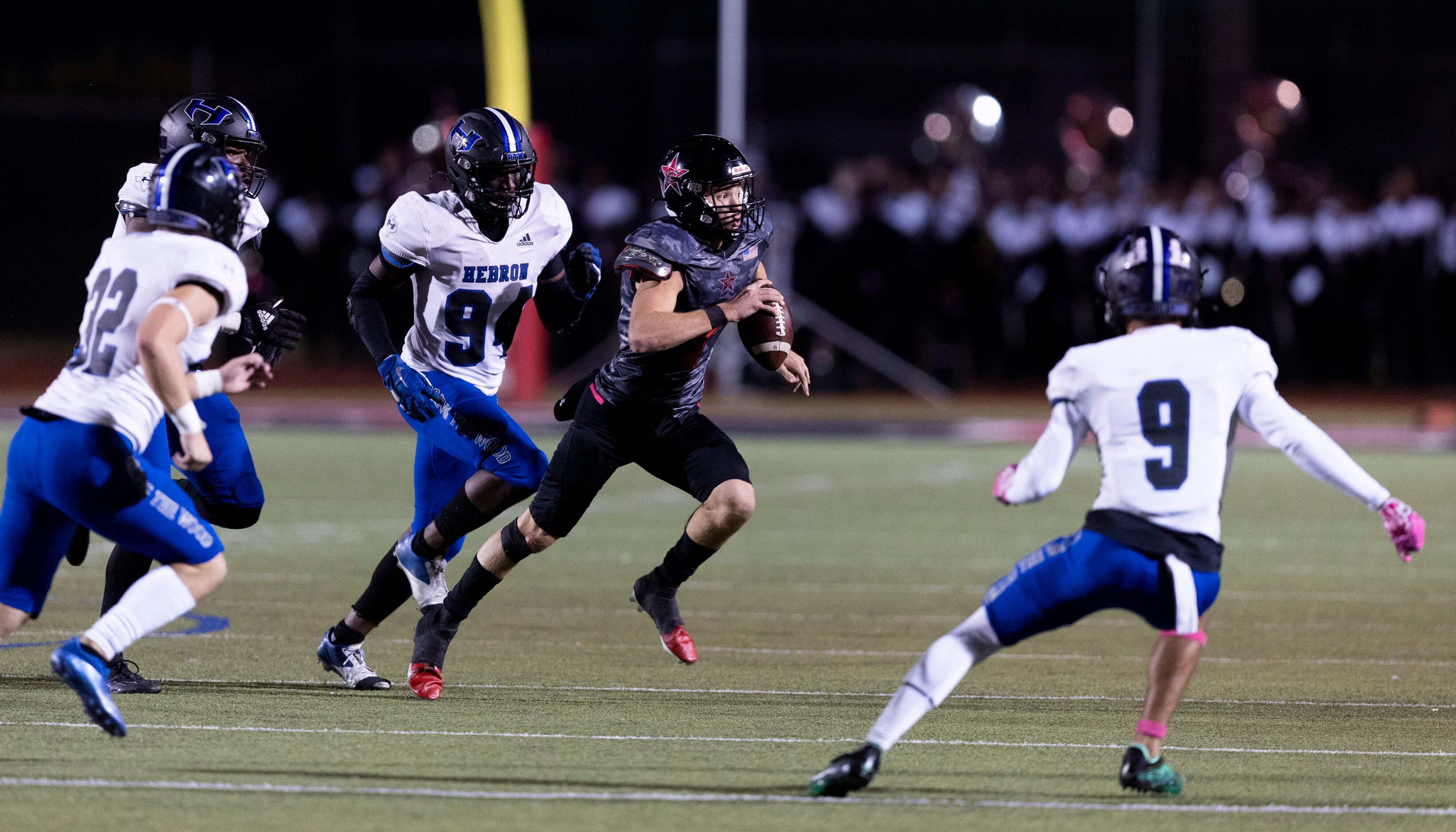 Coppell senior quarterback Jack Fishpaw (7) looks for room against the Hebron defense during...