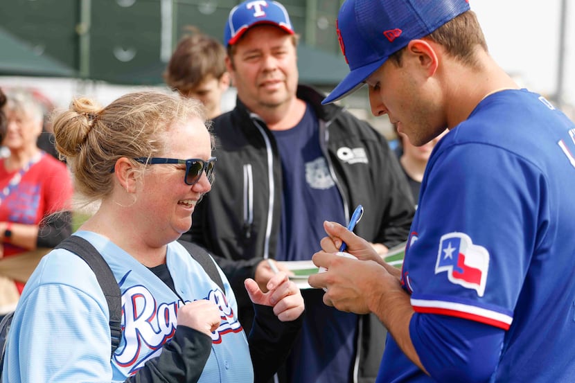 Rachel Clark, left, of DFW area reacts as she receives an autograph from Texas Rangers...