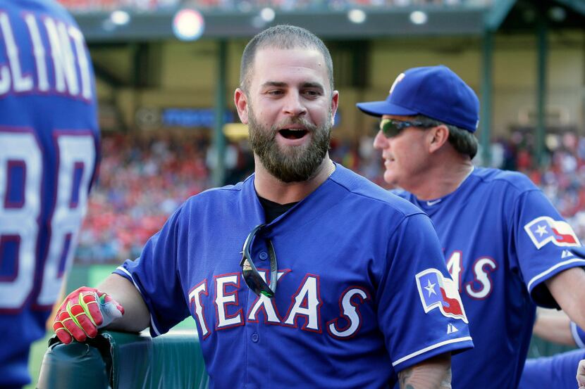 FILE - In this Oct. 4, 2015, file photo, Texas Rangers' Mike Napoli talks with teammates in...